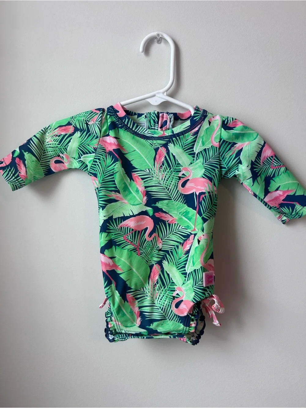 Ruffle Butts Navy One-Piece Swim with Pink Flamingo & Green Leaves